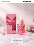 Kiss Beauty La Bloom Sérum Radiante con Vitamina C y Ácido Hialurónico - frasco rosa con cuentagotas y caja